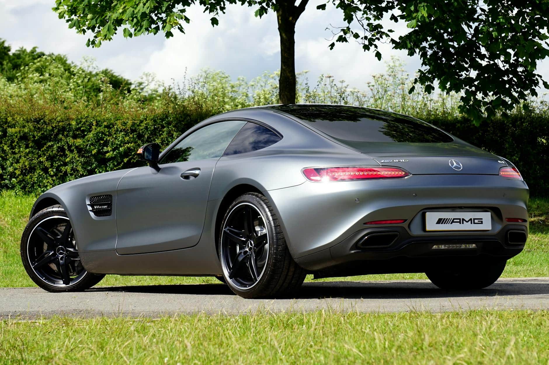 gray mercedes benz amg coupe parked near tree