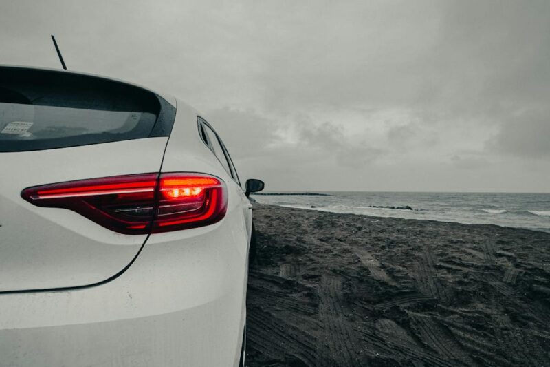 white car on the beach at dusk