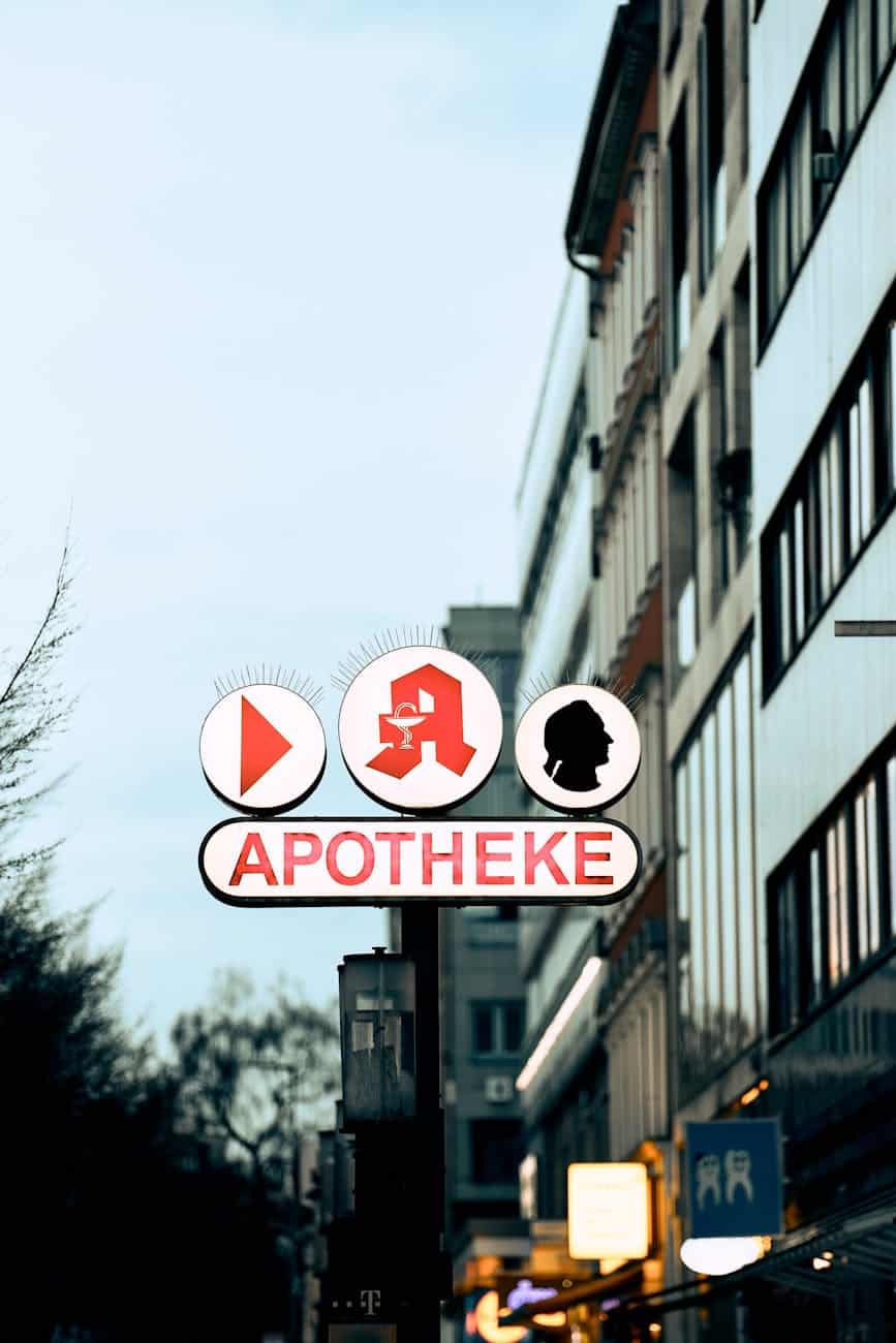 a sign of a pharmacy on the street in city